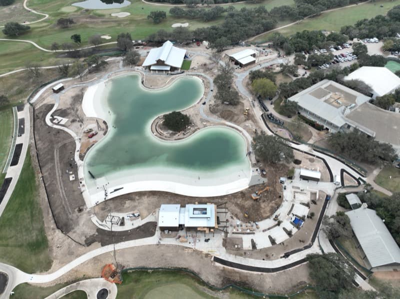 Resort lagoon pool with concrete decking and retaining walls