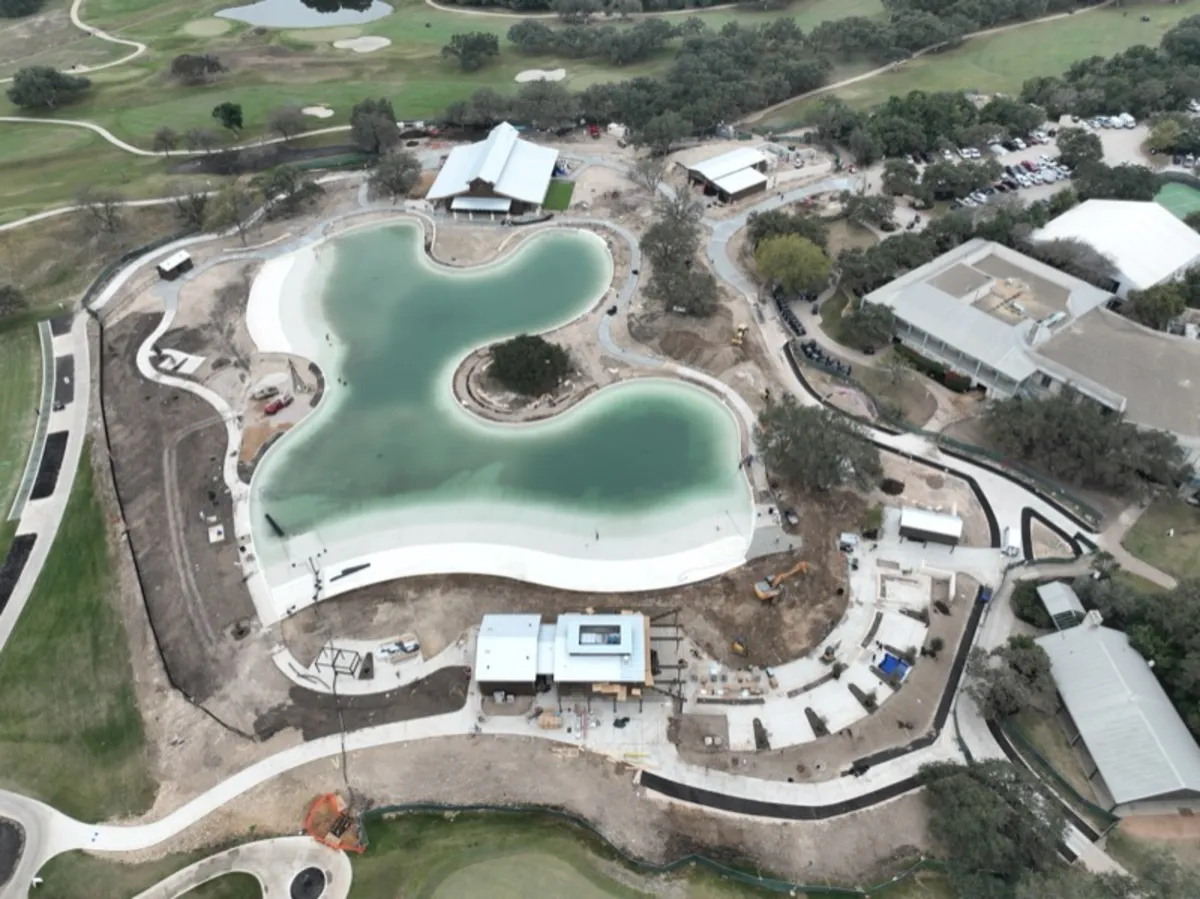 Resort lagoon pool with concrete decking and retaining walls